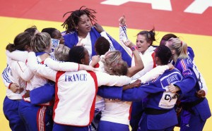 Competitors from France celebrate their victory against Japan in the women's gold medal match at the World Judo Teams Championships in Paris