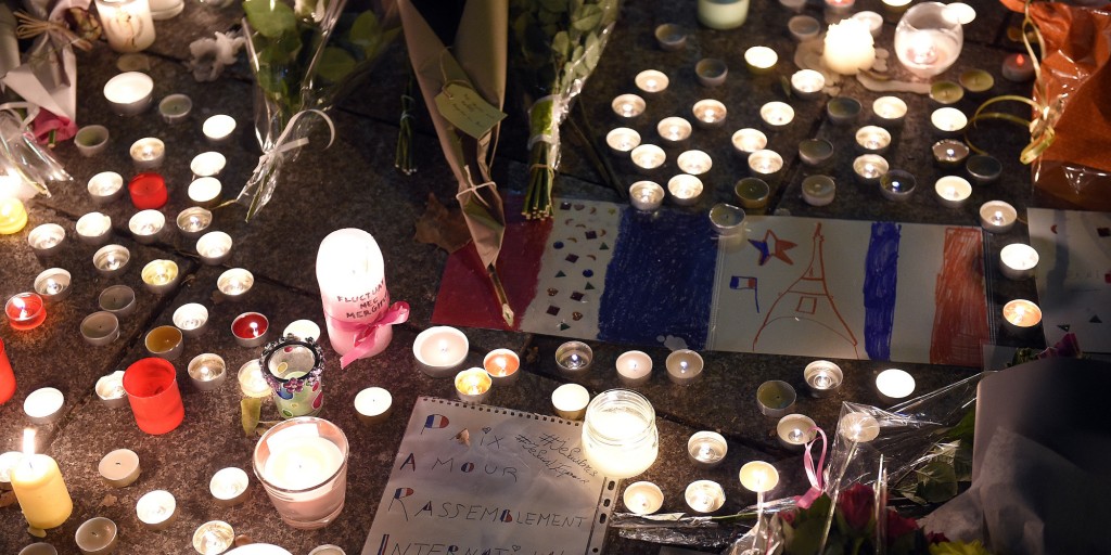 Flowers and candles are pictured near the Bataclan concert hall on November 14, 2015 in Paris, a day after a series of coordinated attacks in and around Paris. Islamic State jihadists claimed a series of coordinated attacks by gunmen and suicide bombers in Paris that killed at least 129 people in scenes of carnage at a concert hall, restaurants and the national stadium. AFP PHOTO / FRANCK FIFE