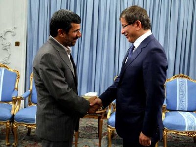 epa02820311 A handout picture released by Iranian Presidential Official Website on 12 July 2011, shows Iranian President Mahmoud Ahmadinejad (L) greeting Turkish Foreign minister Ahmet Davutoglu at the presidential office, in Tehran, Iran, on 11 July 2011. Ahmadinejad warned Turkey of 'plots' by the United States and Israel in the ongoing unrest in the Arabic world. Davutoglu was in Tehran for discussing the latest developments in the Arab world, especially the unrests in its southern neighbourhood Syria which is a strategic partner of Iran.  EPA/IRANIAN PRESIDENTIAL OFFICIAL WEBSITE / HO  HANDOUT EDITORIAL USE ONLY/NO SALES